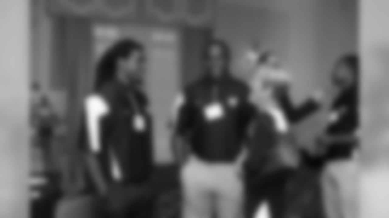 Safety Kemal Ishmael, left, and fullback Devonte Campbell chat with a guest after dinner