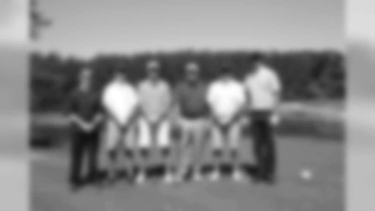 Coach Smith poses with Matt Ryan's group on the golf course
