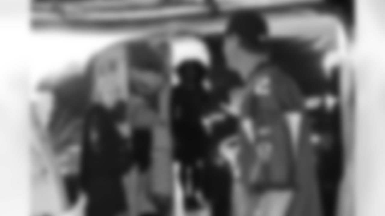 Several Falcons traded places with AirTran workers to marshal planes, take tickets and greet passengers // Trading Places - AirTran // Nov. 1, 2011 // Atlanta -