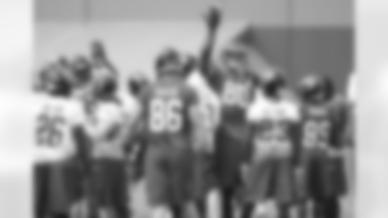 The Falcons give each other high fives before practice