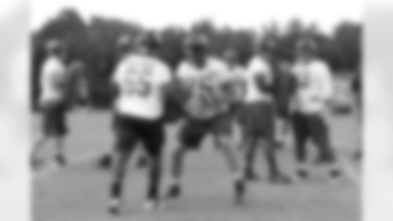 The offensive line works together during practice