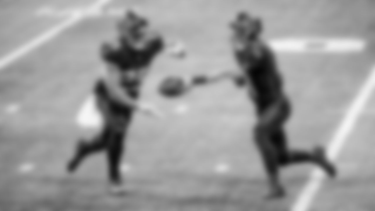 Atlanta Falcons quarterback Desmond Ridder #4 hands the ball off to Atlanta Falcons running back Tyler Allgeier #25 during the second half of a game against the Tampa Bay Buccaneers at Mercedes-Benz Stadium in Atlanta, GA on Sunday, January 8, 2023. (Photo by Casey Sykes/Atlanta Falcons)