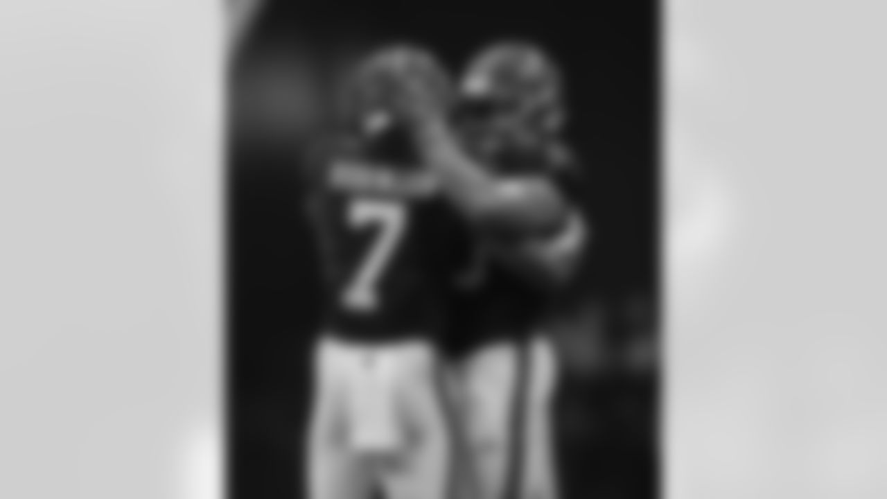 Atlanta Falcons running back Bijan Robinson #7 and Atlanta Falcons fullback Keith Smith #40 hug during the Week 2 Game against the Green Bay Packers at Mercedes-Benz Stadium in Atlanta, Georgia on Sunday, September 17, 2023. (Photo by Shanna Lockwood/Atlanta Falcons)