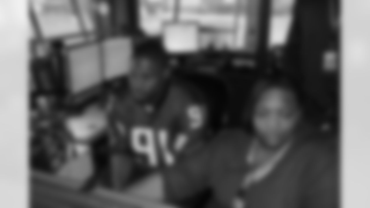 Several Falcons traded places with AirTran workers to marshal planes, take tickets and greet passengers // Trading Places - AirTran // Nov. 1, 2011 // Atlanta -