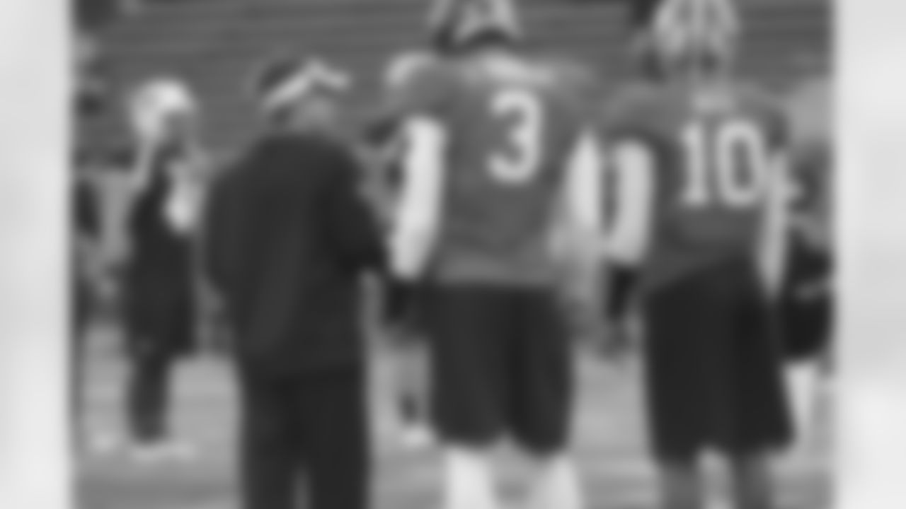 Falcons quarterbacks coach Glenn Thomas, left, works with the North team signal-callers.
