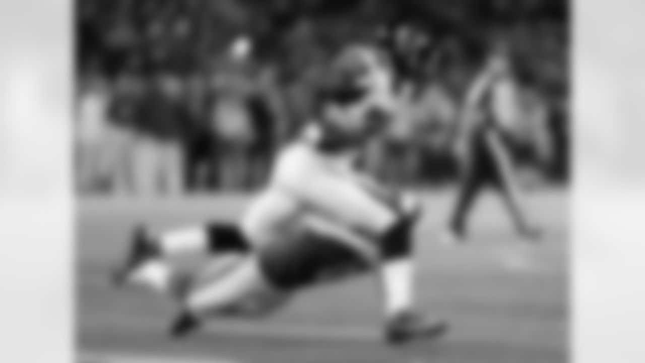 RB Antone Smith runs the ball as Bills K Dan Carpenter attempts to make a tackle