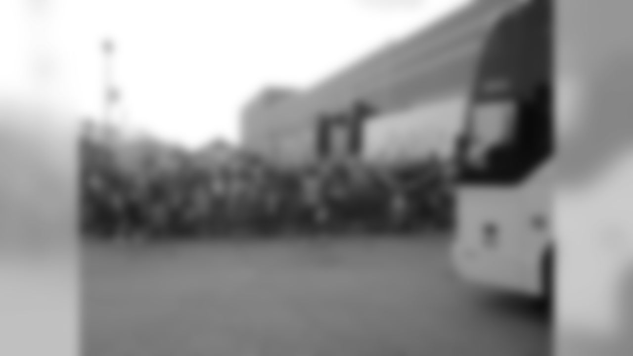 Fans applaud as the first Falcons bus slows to a stop in front of Norcross High School. // 2011 Friday Night Lights // August 5, 2011 // Norcross, Ga. —