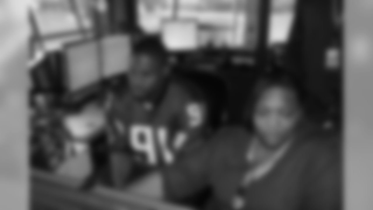 Several Falcons traded places with AirTran workers to marshal planes, take tickets and greet passengers // Trading Places - AirTran // Nov. 1, 2011 // Atlanta -