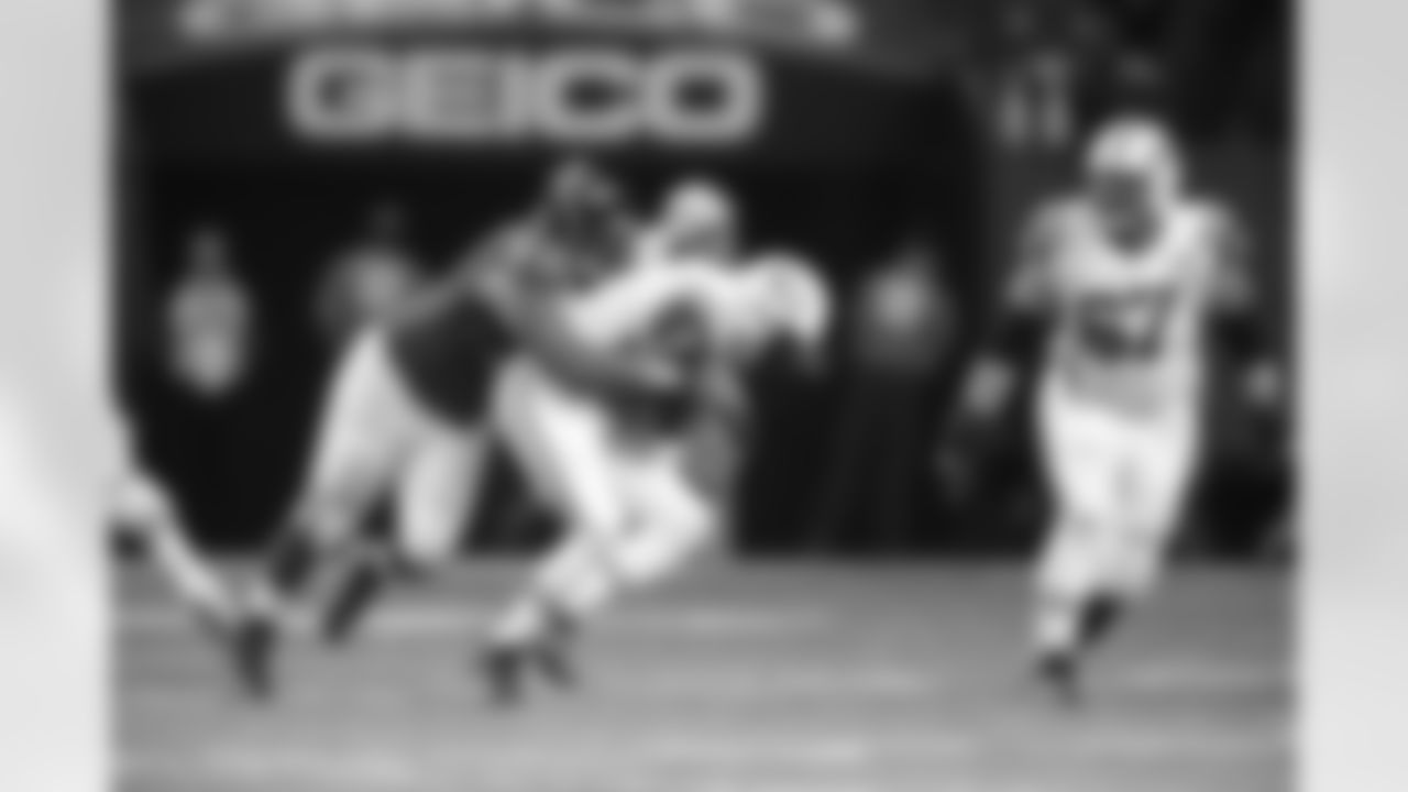 DT Corey Peters wraps up around Jets QB Geno Smith