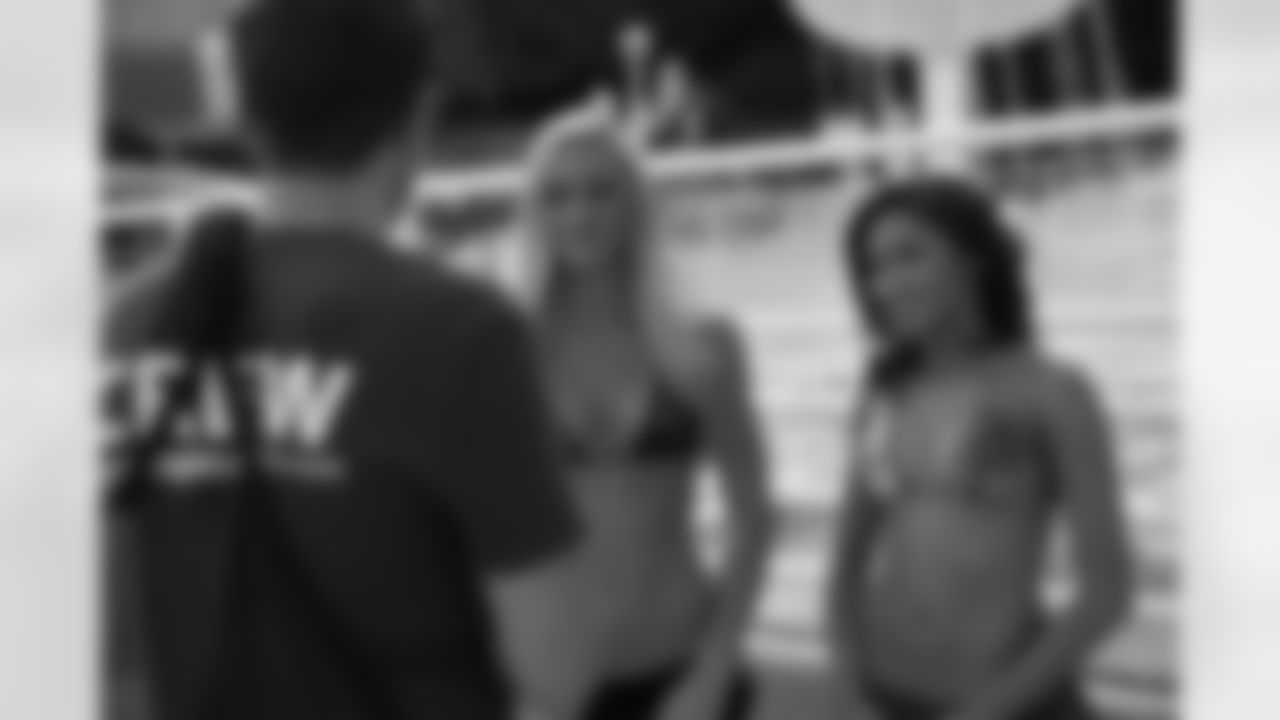 Kat M. and Brittiney W. listen to the photographer's advice before their shoot