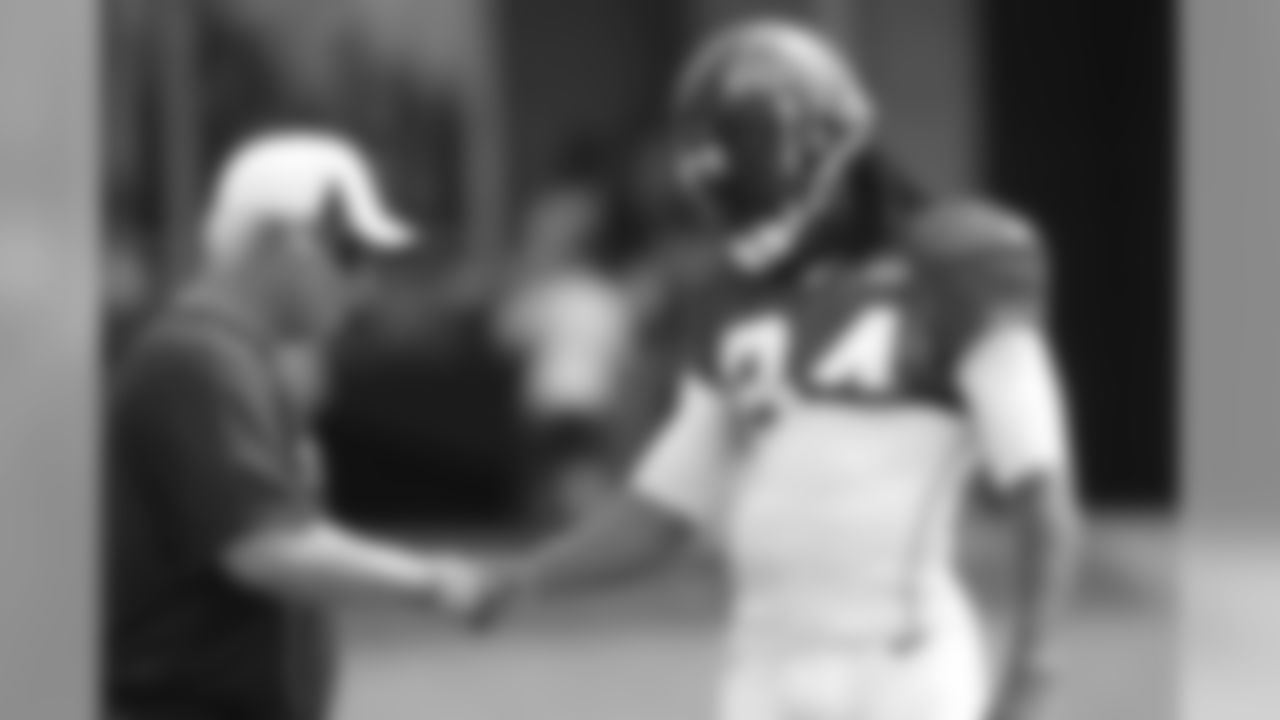 Head coach Mike Smith gives WR Roddy White a fist bump during practice