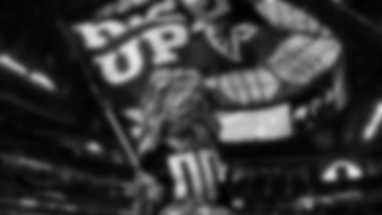 Freddie Falcon waives the Rise Up flag before the game against the Tampa Bay Buccaneers on December 20, 2020.