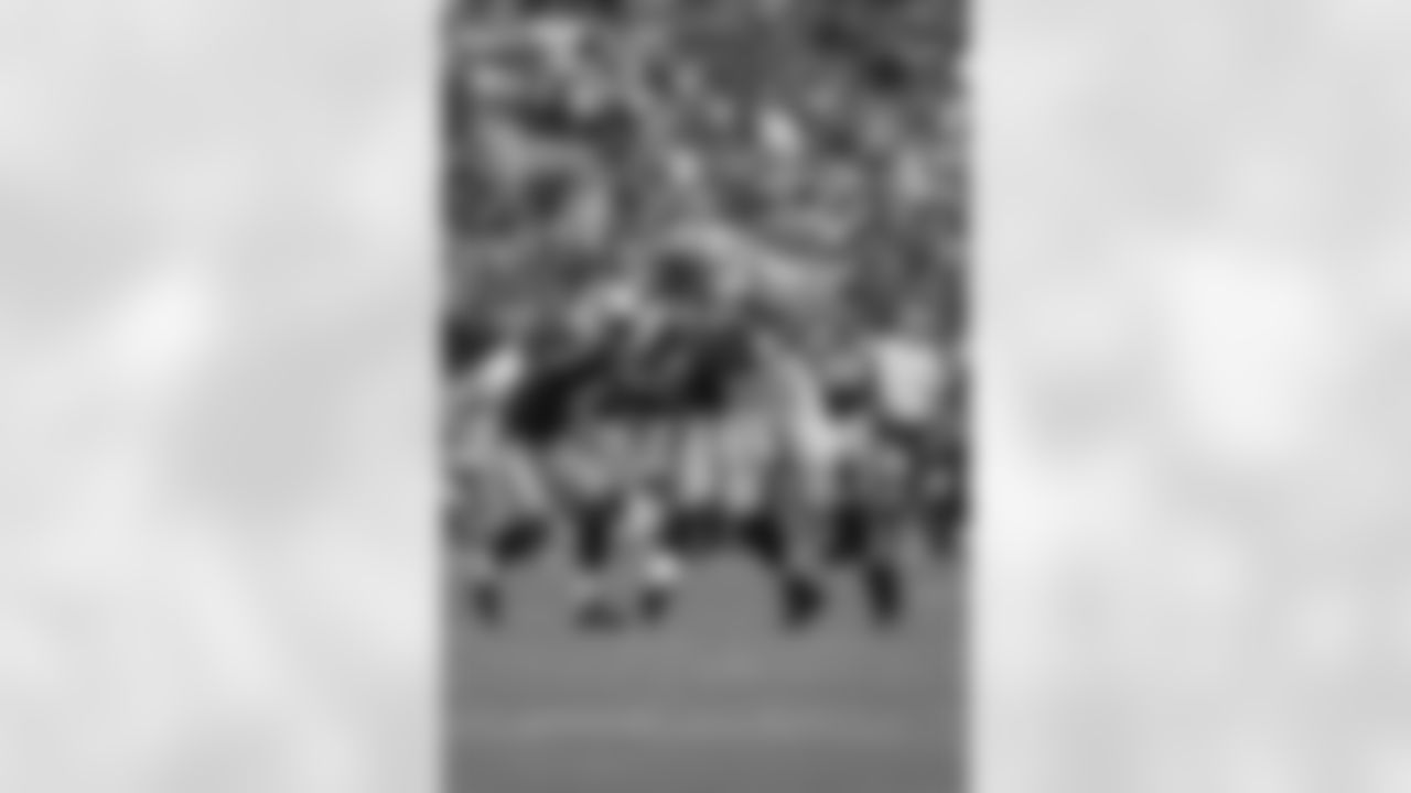 TE Tony Gonzalez tries to pull away from two Carolina defenders after the catch