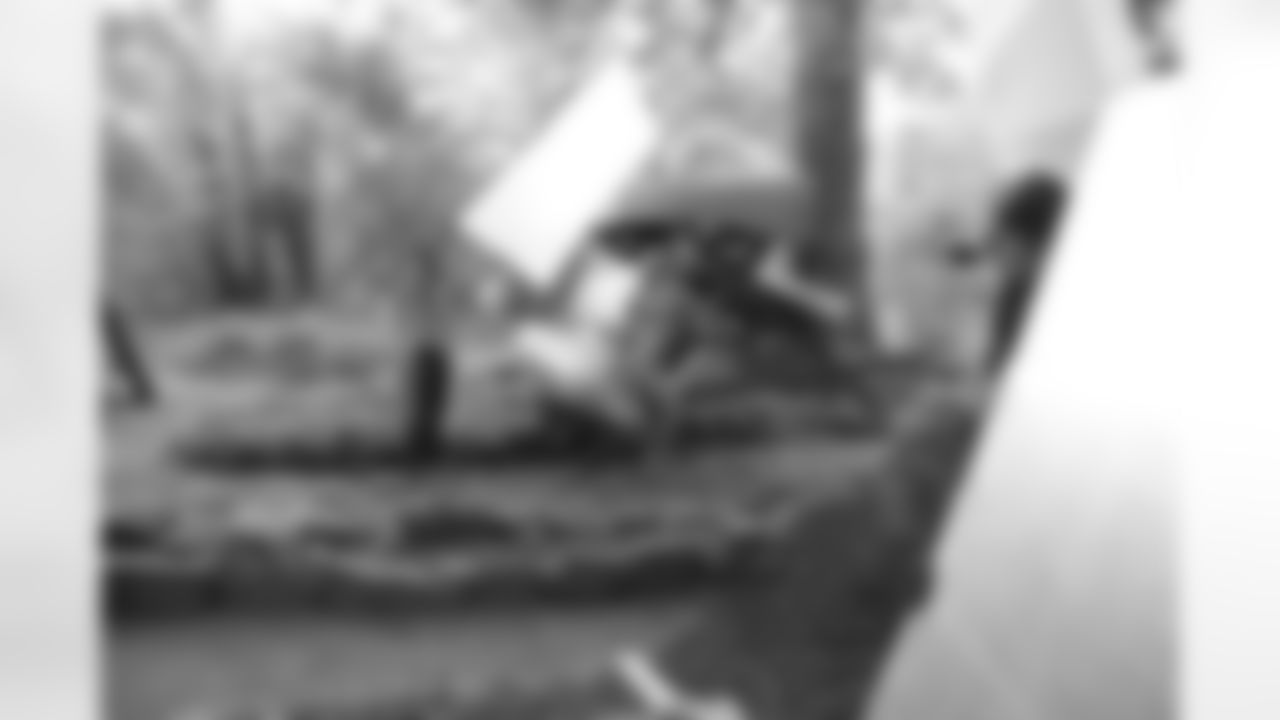 Natalie B. takes photos by a few canoes