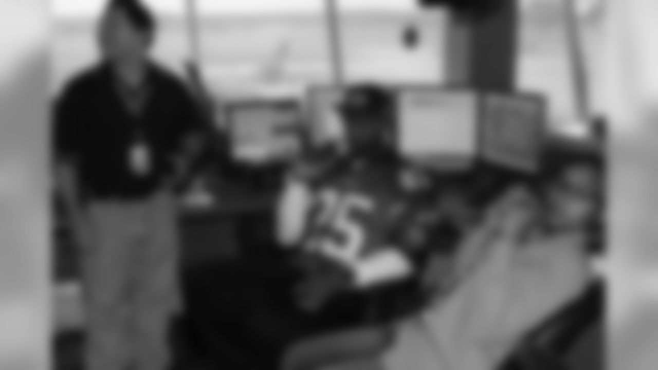 Several Falcons traded places with AirTran workers to marshal planes, take tickets and greet passengers // Trading Places - AirTran // Nov. 1, 2011 // Atlanta -