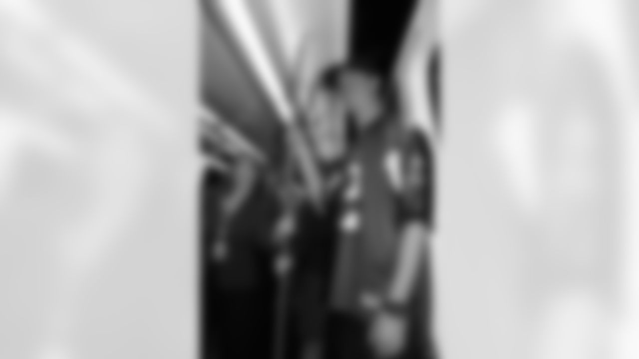 Several Falcons traded places with AirTran workers to marshal planes, take tickets and greet passengers // Trading Places - AirTran // Nov. 1, 2011 // Atlanta -