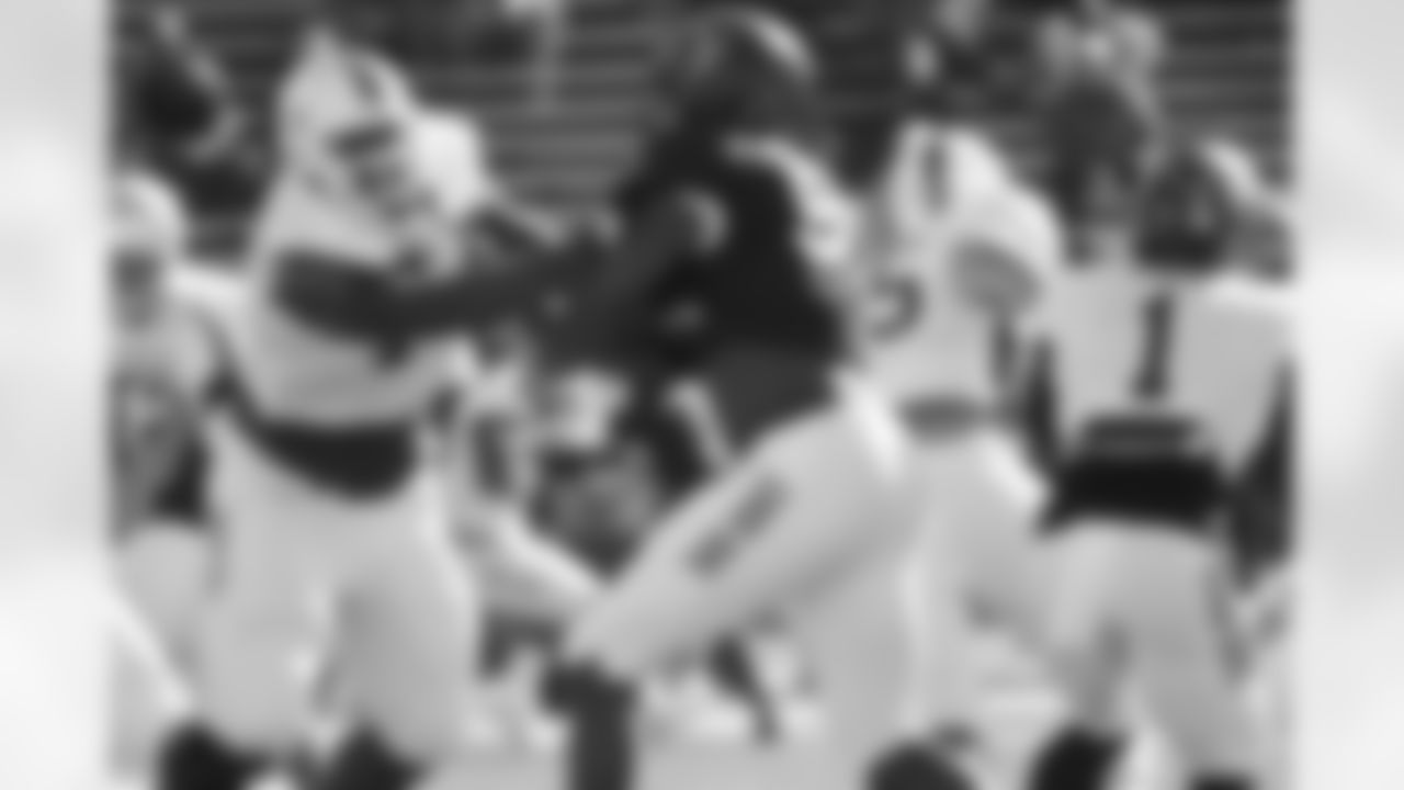 Miami OT Seantrel Henderson works against West Virginia DE Will Clarke