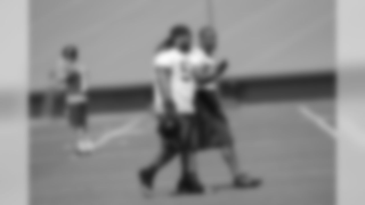 Defensive linemen Paul Soliai and Osi Umenyiora chat while walking to their next drill