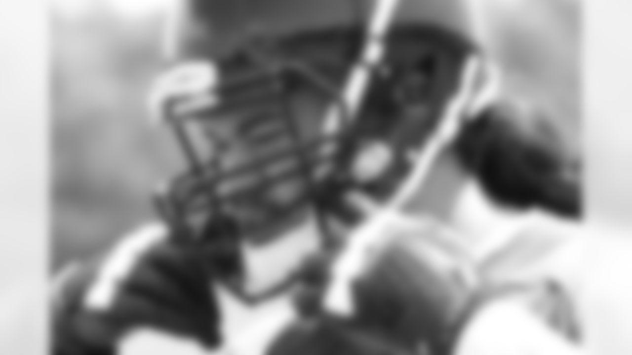 Fresno State tackle Alex Fifita adjusts his helmet