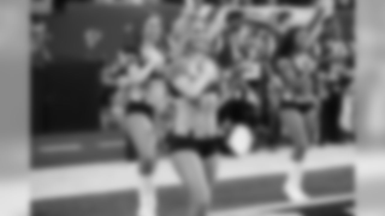 Sabrina C. and the rest of the Atlanta Falcons Cheerleaders pause for the National Anthem