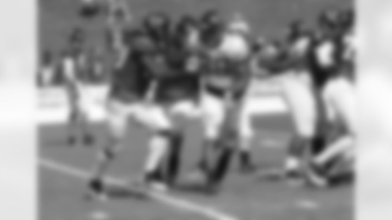 RB Steven Jackson protects the ball as he approaches DE Cliff Matthews
