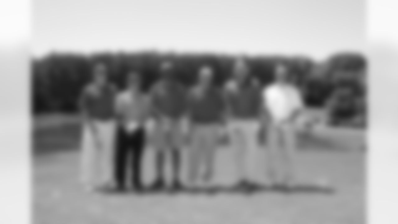 Former Falcons Michael Haynes and Steve Bartkowski pose with Coach Smith and the rest of their group
