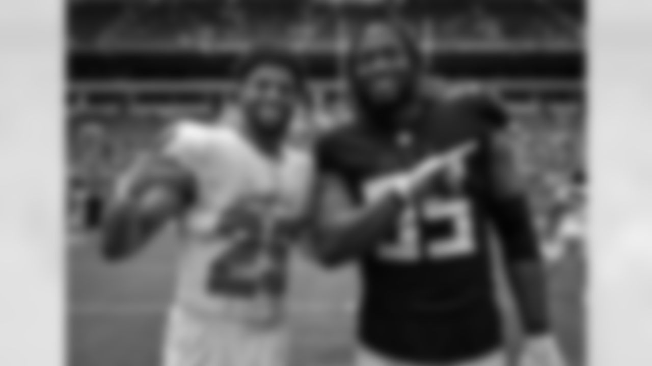 Atlanta Falcons defensive tackle Ta'Quon Graham #95 and Miami Dolphins defensive back Brandon Jones #29 pose after their game at Hard Rock Stadium in Miami Gardens, Florida on Sunday, October 24, 2021. (Photo by Adler Garfield/Atlanta Falcons)
