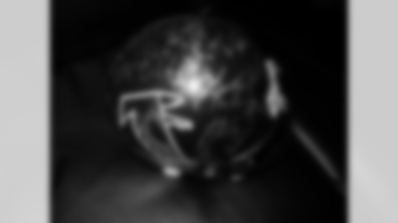 Stone Sour guitarist Josh Rand shows off his helmet signed by the entire 1998 Super Bowl team