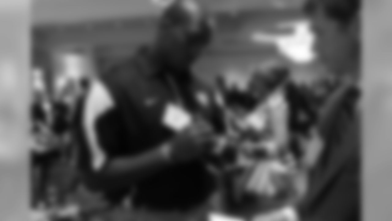 Defensive end Malliciah Goodman signs a Falcons mini helmet
