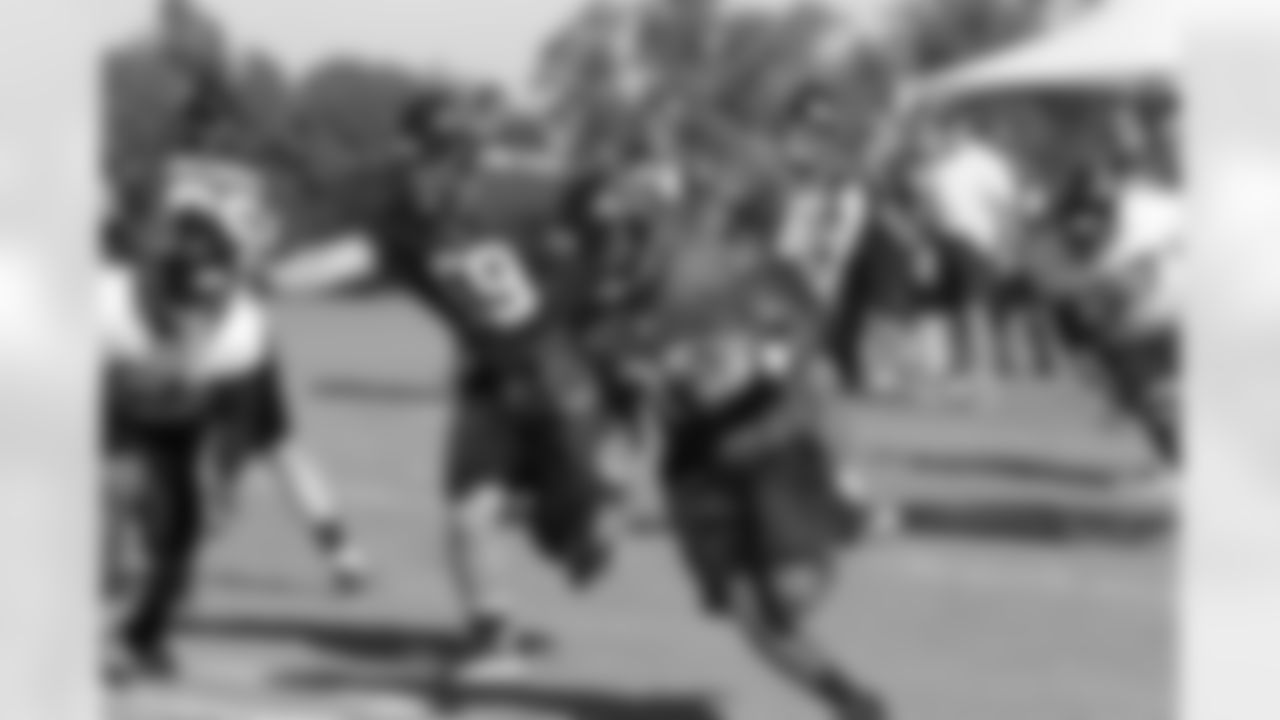 RB Antone Smith runs around a block from OL Andrew Jackson // 2011 Russell Athletic Training Camp - Day 10 // August 10, 2011 // Flowery Branch, Ga. —