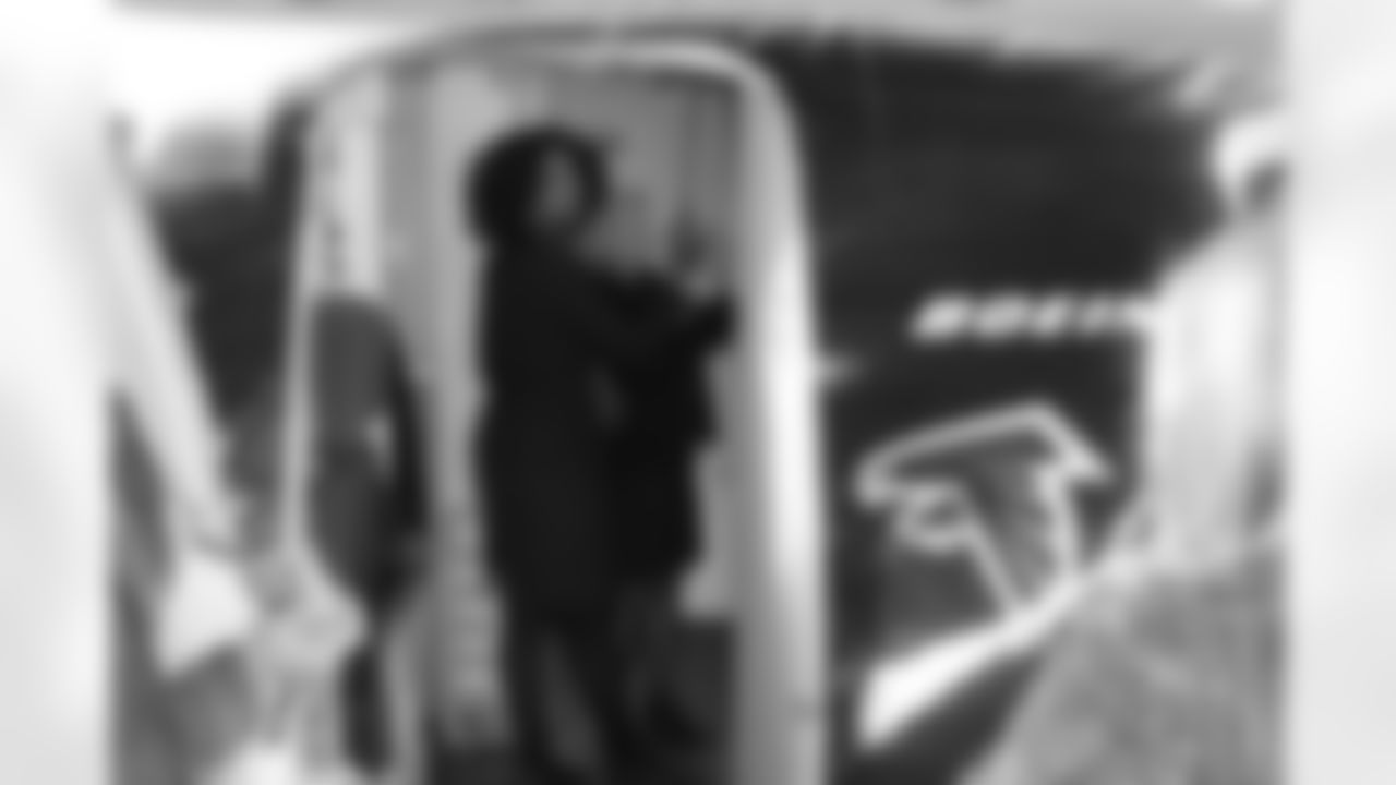 Several Falcons traded places with AirTran workers to marshal planes, take tickets and greet passengers // Trading Places - AirTran // Nov. 1, 2011 // Atlanta -