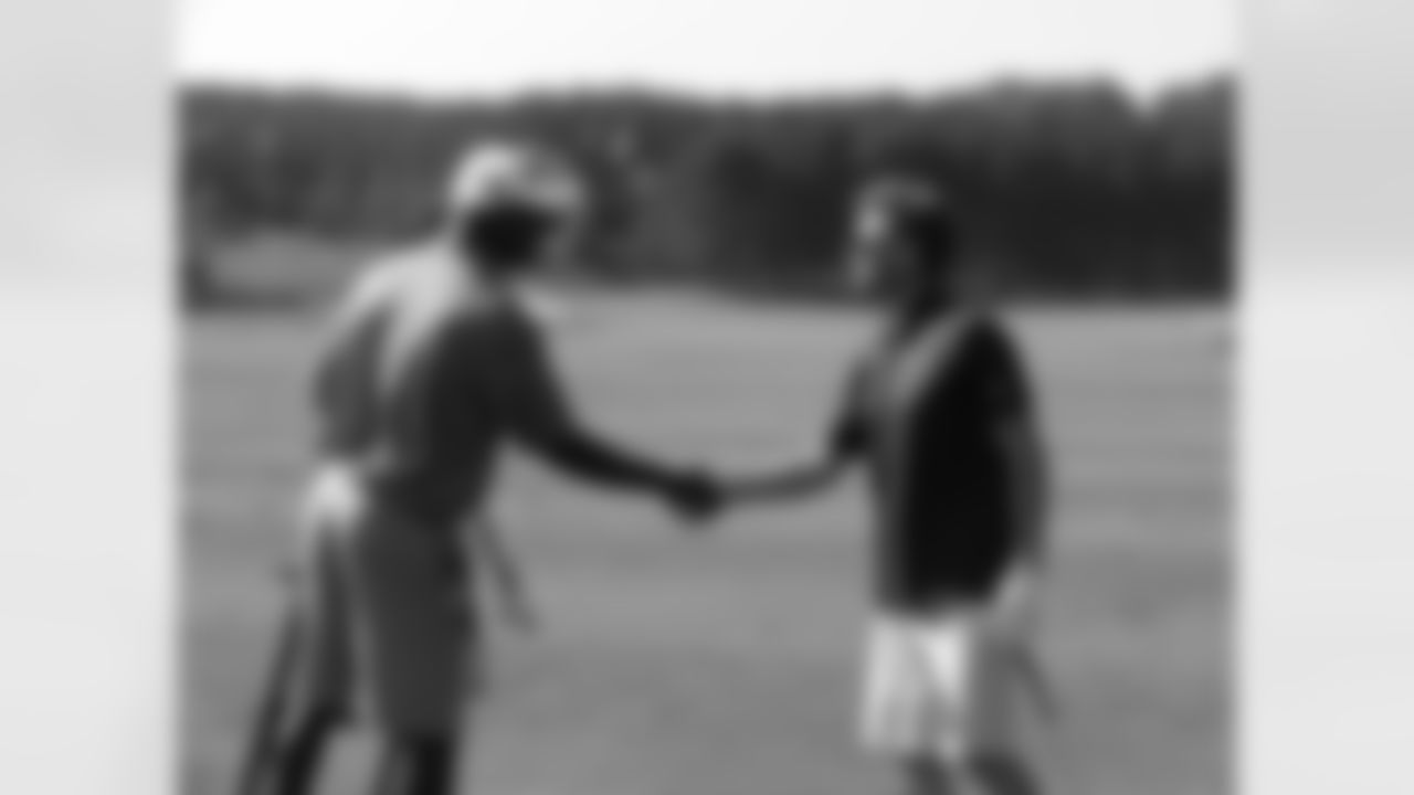 Falcons special teams coach Keith Armstrong, left, says hello to Falcons general manager Thomas Dimitroff // Seventh Annual Verizon Network of Champions Golf Tournament // 6/13/11 // Suwanee, Ga. -