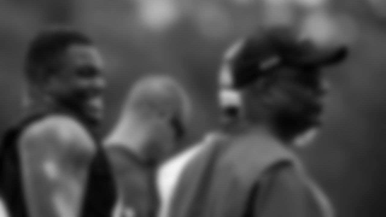 Atlanta Falcons defensive end Marlon Davidson #90 talks to Gary Emanuel during organized team activities in Phase III of the Atlanta Falcons offseason program on June 2, 2021.