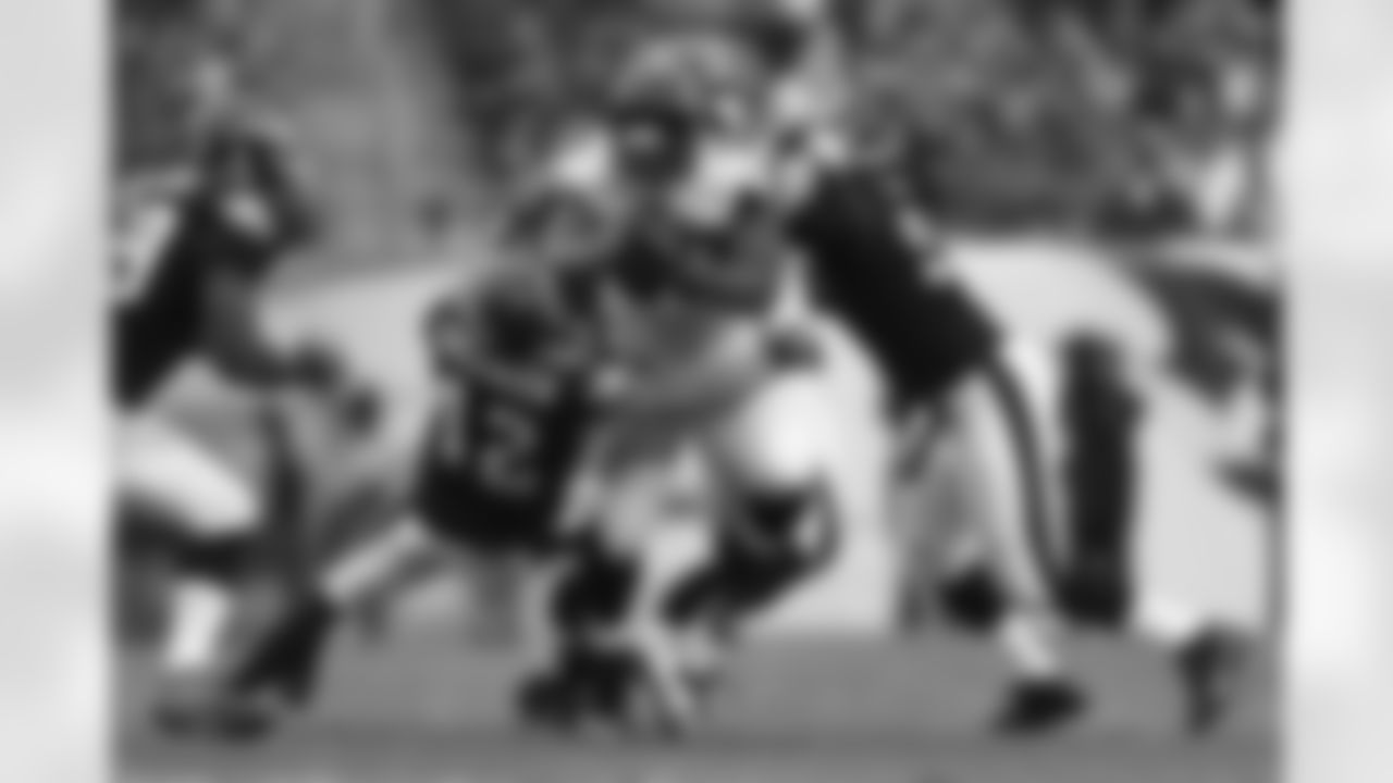 Multiple defenders try to take down RB Michael Turner