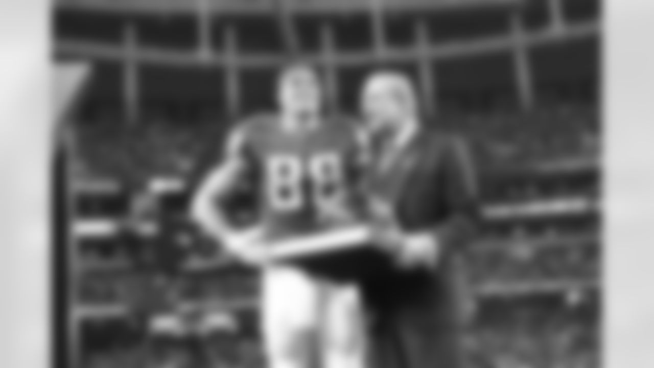 Falcons Owner and Chairman Arthur Blank presents TE Tony Gonzalez with a special helmet at half time
