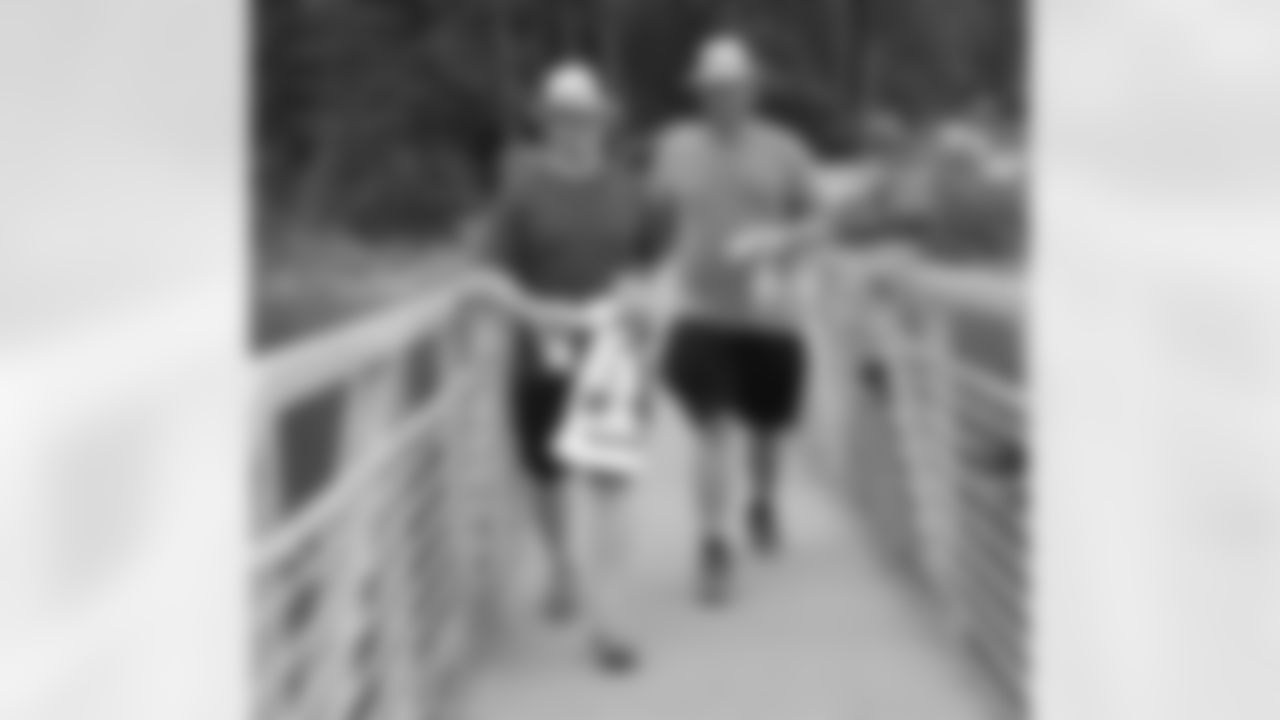 Fullback Bradie Ewing and offensive lineman Peter Konz walk onto the dock to get on their boat