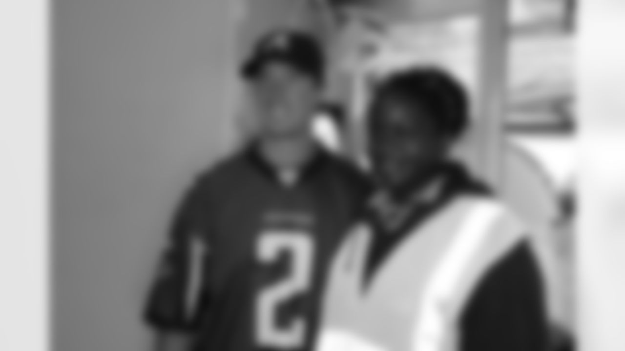 Several Falcons traded places with AirTran workers to marshal planes, take tickets and greet passengers // Trading Places - AirTran // Nov. 1, 2011 // Atlanta -