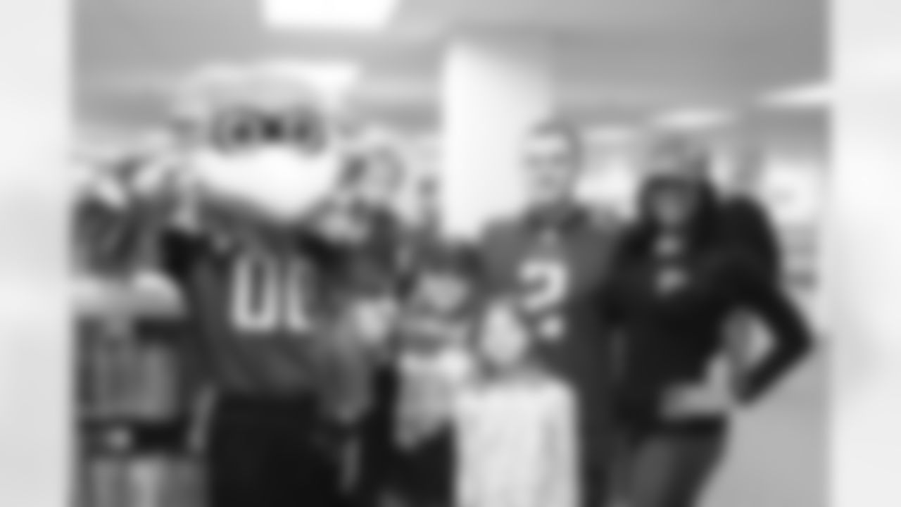 Denita C. and Freddie Falcon pose with a few Falcons fans in Alaska