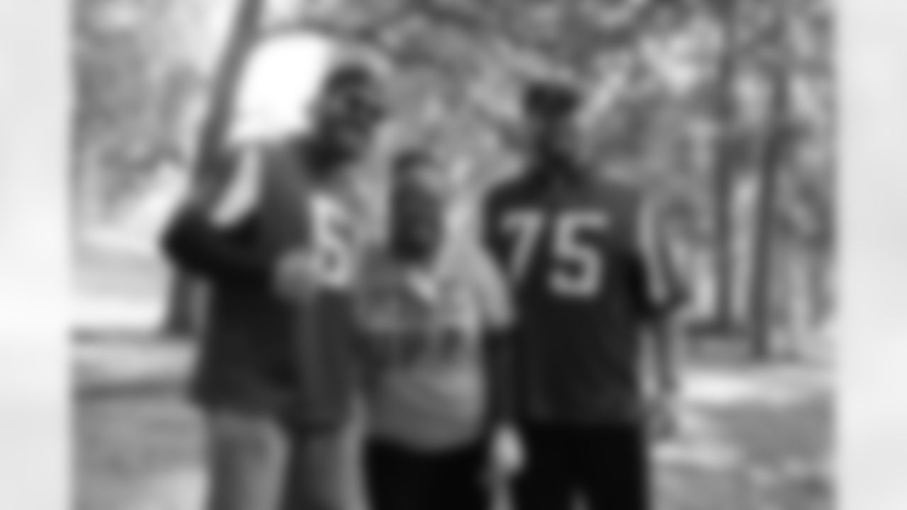 Offensive linemen Joe Hawley and Garrett Reynolds with a volunteer