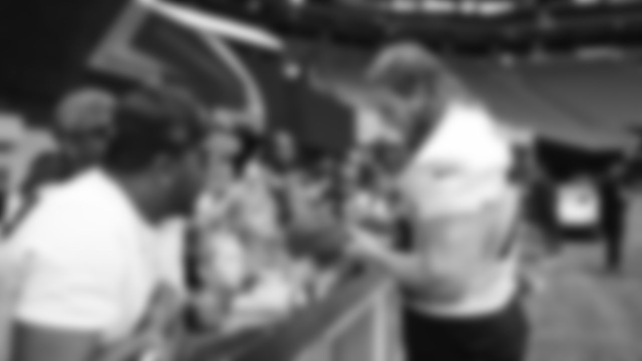 Atlanta Falcons tackle Kaleb McGary #76 signs autographs for fans during the Falcons First Look practice at Mercedes-Benz Stadium in Atlanta, Georgia on Friday, June 3, 2022. (Photo by Shanna Lockwood/Atlanta Falcons)