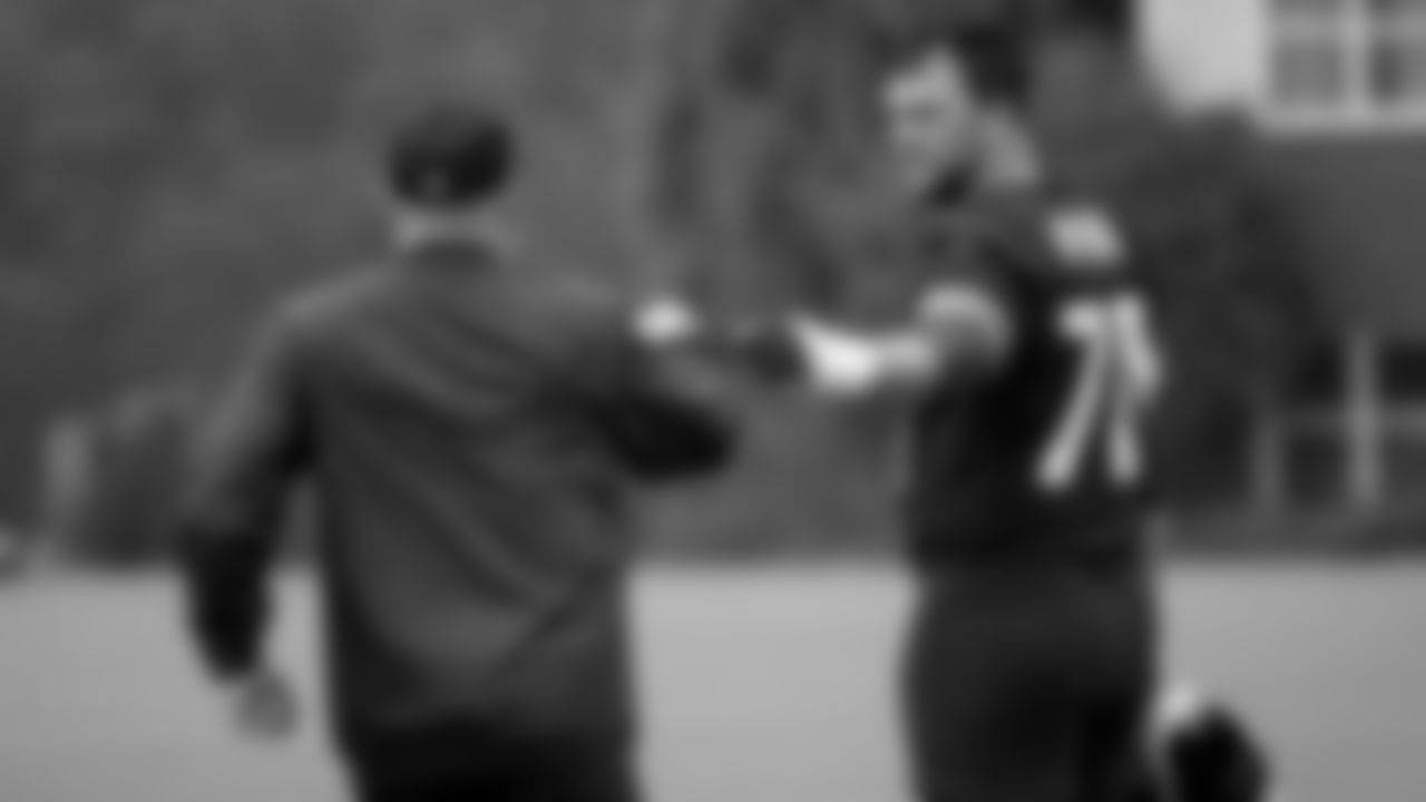 Atlanta Falcons offensive tackle Jake Matthews #70 fist bumps coach Dave Brock during practice at IBM Performance Field. (Photo by Kara Durrette/Atlanta Falcons)