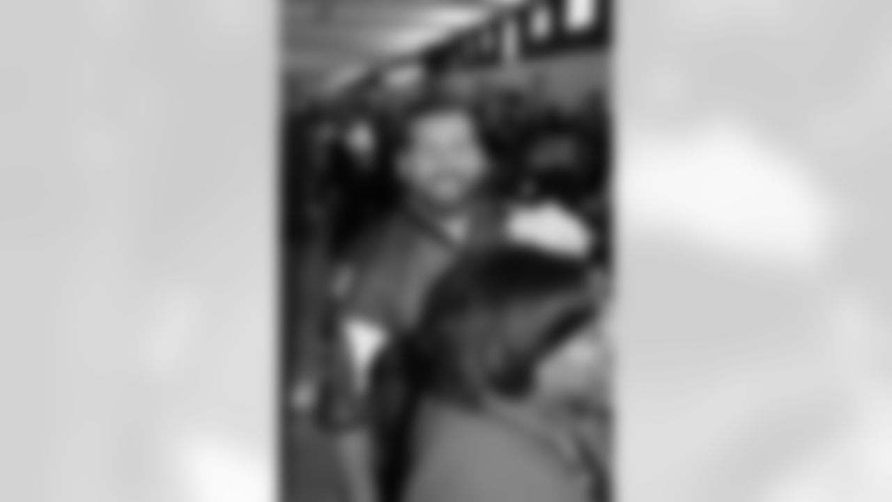 Several Falcons traded places with AirTran workers to marshal planes, take tickets and greet passengers // Trading Places - AirTran // Nov. 1, 2011 // Atlanta -