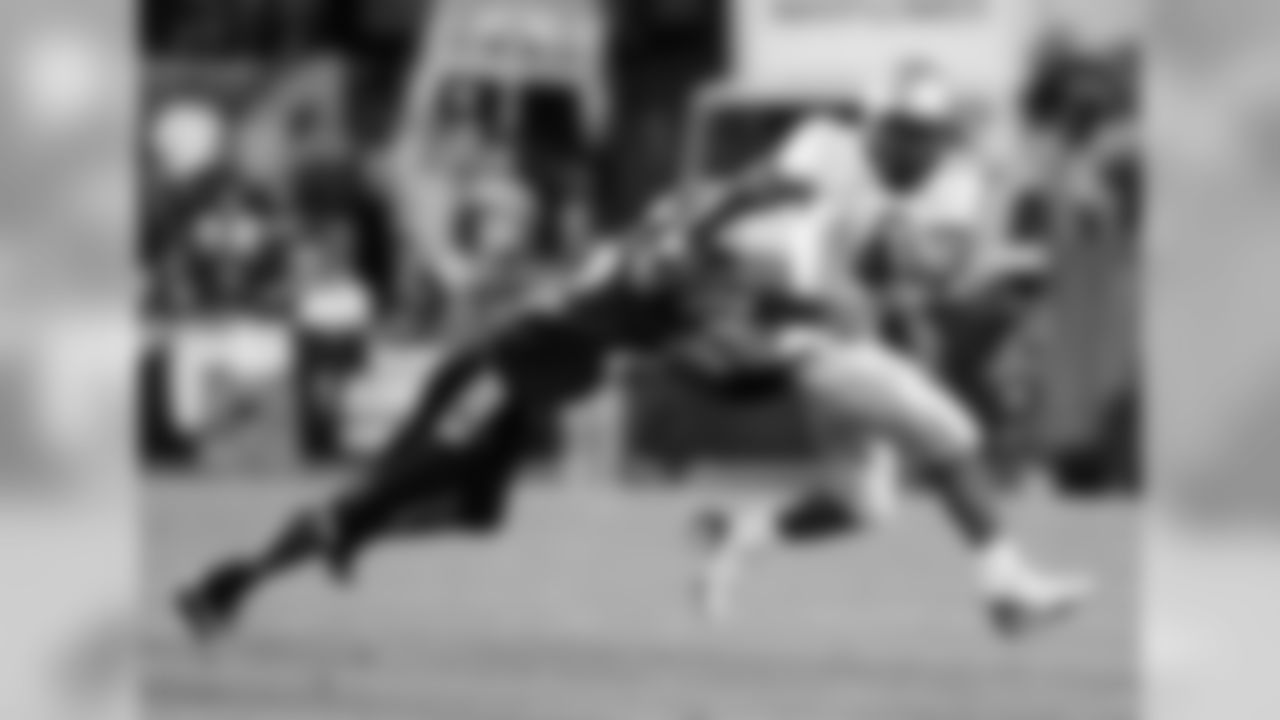 A Colorado University player attempts to tackle RB Antone Smith during a game in 2007.