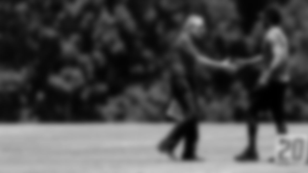 Atlanta Falcons owner Arthur Blank shakes hands with Atlanta Falcons legend Harry Douglas during organized team activities in Phase III of the Atlanta Falcons offseason program on June 4, 2021.