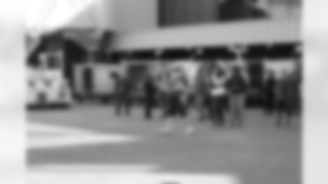 Several Falcons traded places with AirTran workers to marshal planes, take tickets and greet passengers // Trading Places - AirTran // Nov. 1, 2011 // Atlanta -
