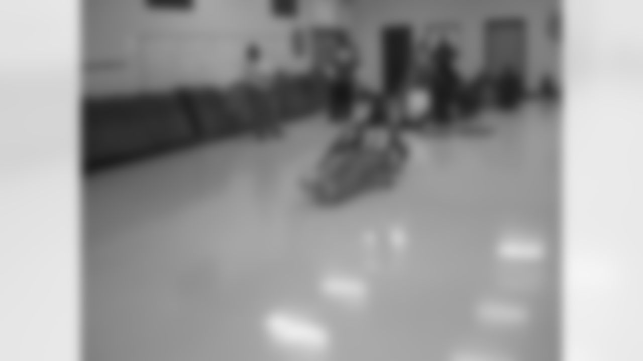 Cornerback Chris Houston enjoys the scooter relay at Grove Park Elementary