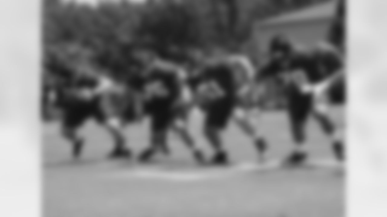 Offensive linemen react to the snap during Friday's practice session