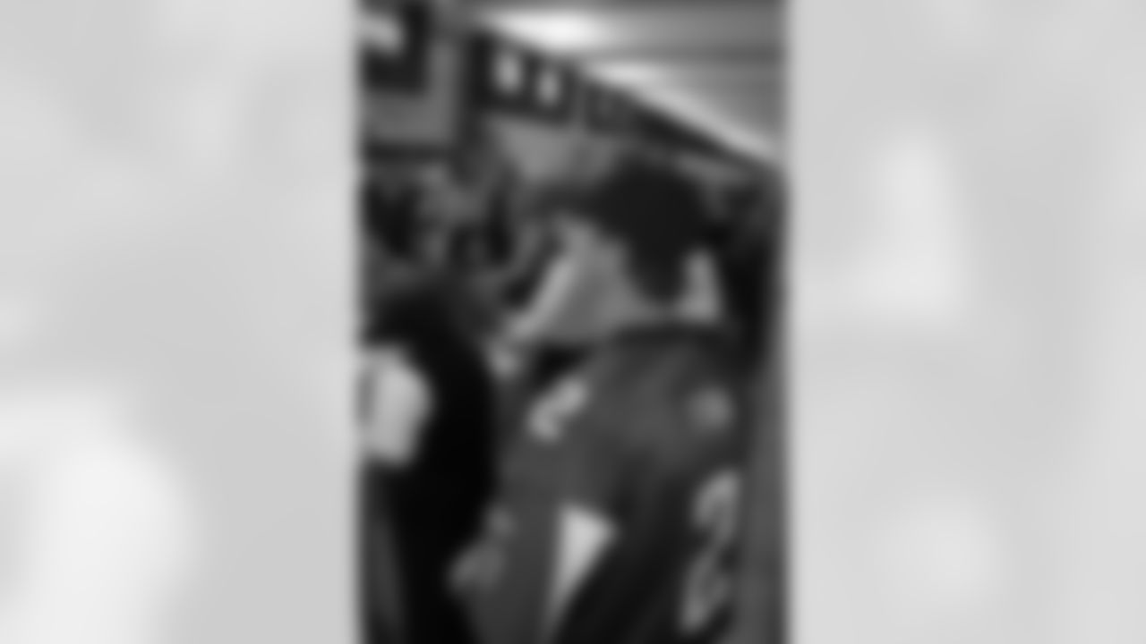 Several Falcons traded places with AirTran workers to marshal planes, take tickets and greet passengers // Trading Places - AirTran // Nov. 1, 2011 // Atlanta -