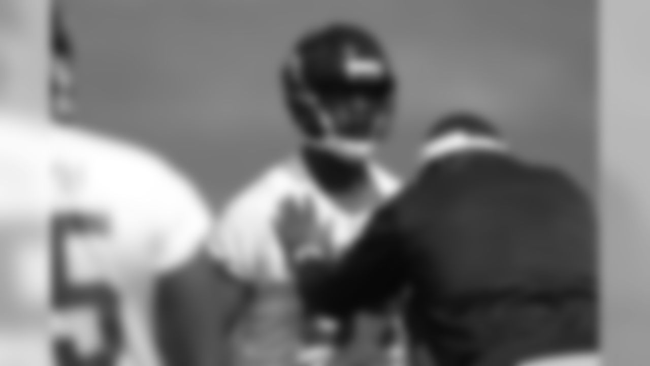 Defensive line coach Bryan Cox works with DE Nosa Eguae