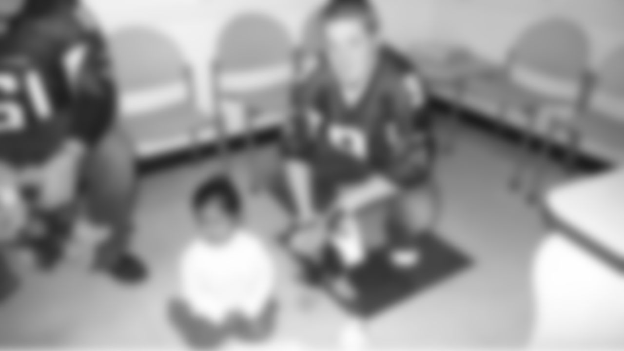 The Atlanta Facons visit Children's Healthcare of Atlanta // Atlanta, GA // Michael Koenen with a patient //